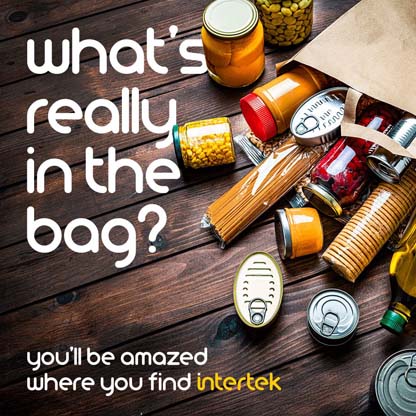 Grocery items pouring out of a paper bag